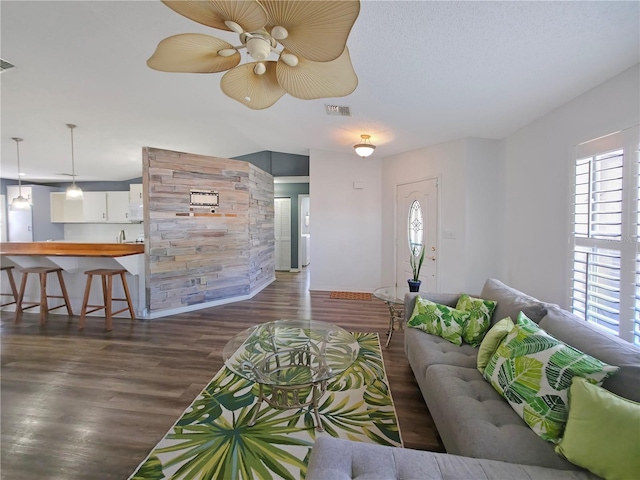 6106 Kittiwake Dr, Lakeland, FL 33809 - living area with visible vents, dark wood-type flooring, and a ceiling fan