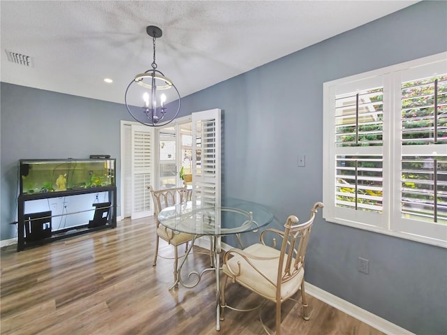 6106 Kittiwake Dr, Lakeland, FL 33809 - dining space with a notable chandelier, visible vents, baseboards, and wood finished floors