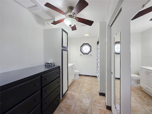 6106 Kittiwake Dr, Lakeland, FL 33809 - bathroom featuring vanity, tile patterned floors, toilet, and a ceiling fan