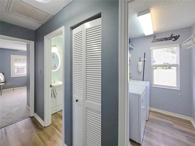 6106 Kittiwake Dr, Lakeland, FL 33809 - laundry area with visible vents, a textured ceiling, wood finished floors, baseboards, and laundry area