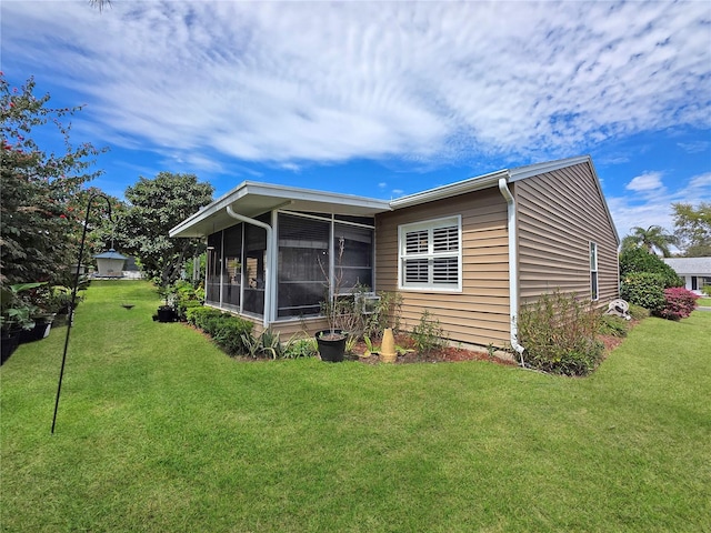 6106 Kittiwake Dr, Lakeland, FL 33809 - rear view of property with a lawn and a sunroom