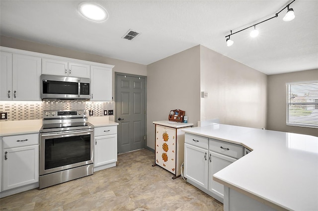 kitchen featuring stainless steel appliances, light countertops, visible vents, and white cabinetry