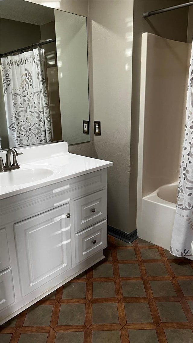 bathroom with shower / bathtub combination with curtain and vanity