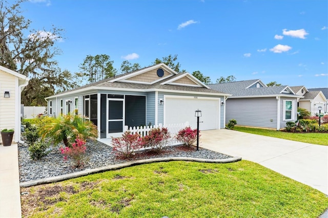 ranch-style home with a front lawn, concrete driveway, a shingled roof, and an attached garage