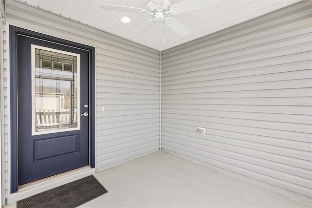 view of exterior entry featuring ceiling fan