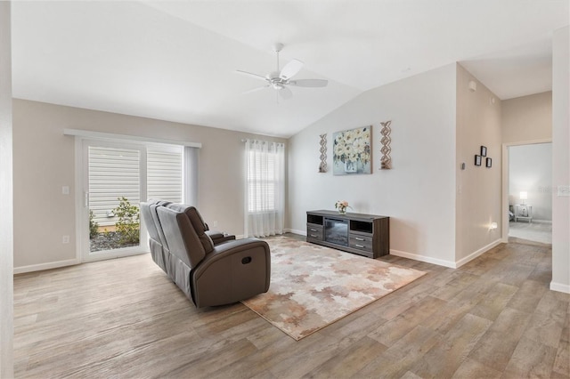 living area with lofted ceiling, baseboards, light wood-style flooring, and a ceiling fan