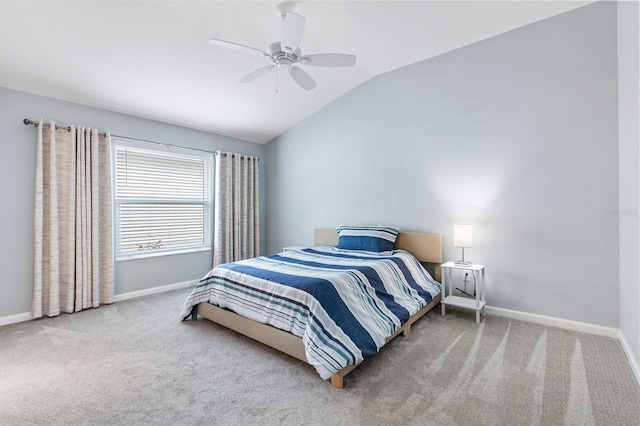 carpeted bedroom with lofted ceiling, baseboards, and a ceiling fan