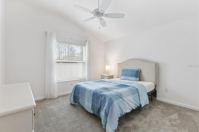 bedroom featuring a ceiling fan, light carpet, vaulted ceiling, and baseboards