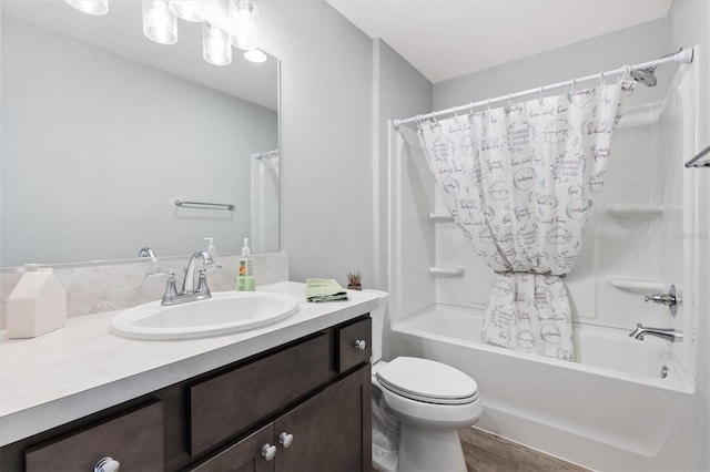 full bathroom featuring toilet, shower / bath combo with shower curtain, and vanity