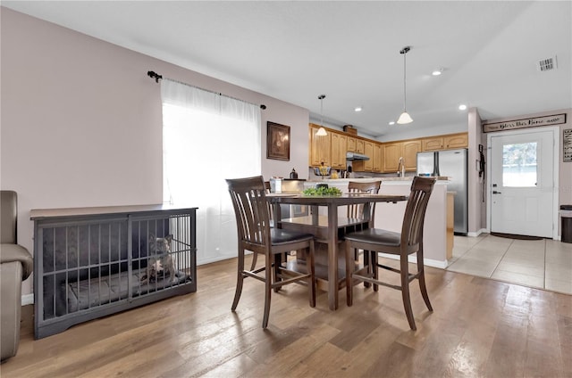 dining space with light wood finished floors, recessed lighting, lofted ceiling, visible vents, and baseboards