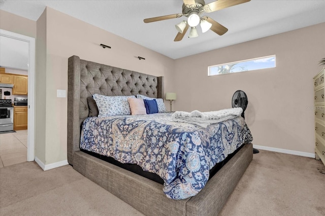 bedroom featuring a ceiling fan, light colored carpet, and baseboards