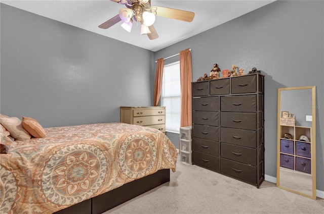 carpeted bedroom with baseboards and a ceiling fan