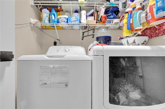 clothes washing area featuring laundry area and washer and clothes dryer