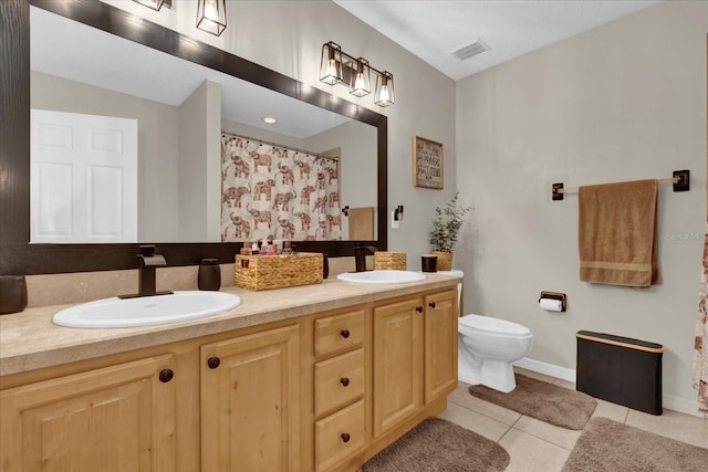 full bathroom featuring double vanity, tile patterned flooring, visible vents, and a sink