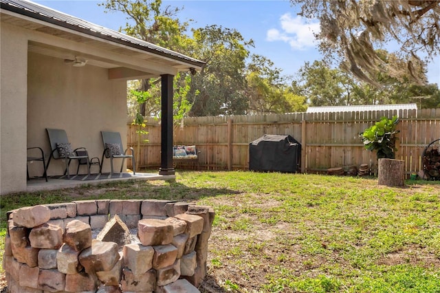 view of yard featuring fence and a fire pit