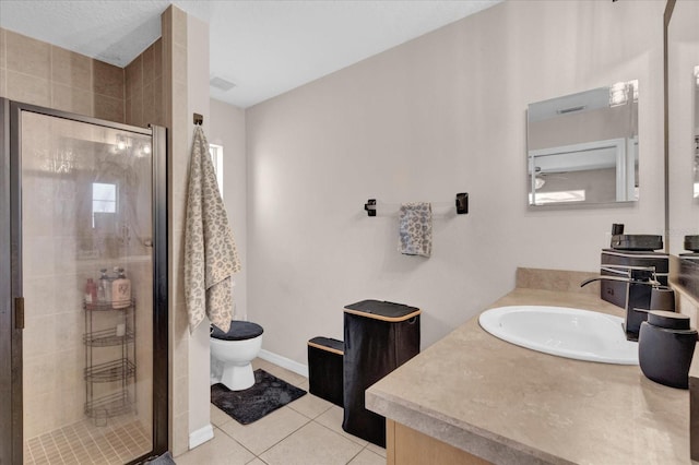 full bathroom with baseboards, toilet, tile patterned flooring, vanity, and a shower stall