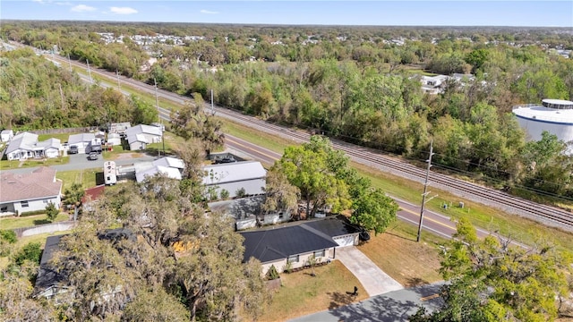 birds eye view of property featuring a view of trees