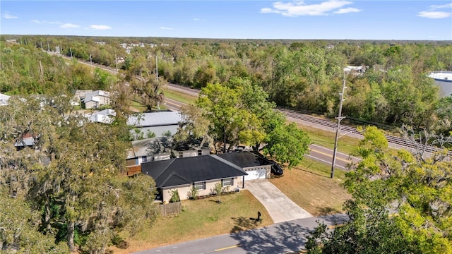 bird's eye view with a wooded view