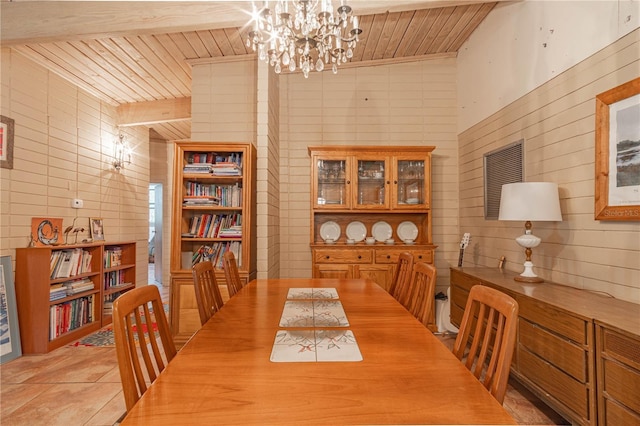 dining space with light tile patterned floors, wood ceiling, and a chandelier