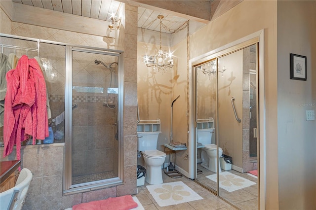 bathroom featuring toilet, a shower stall, a notable chandelier, and tile patterned floors