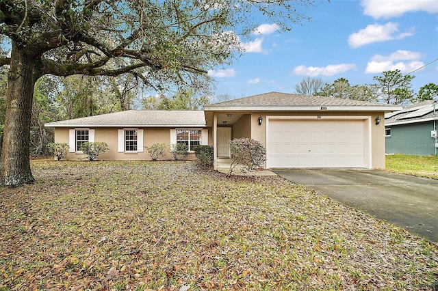 ranch-style house featuring a garage, concrete driveway, and stucco siding