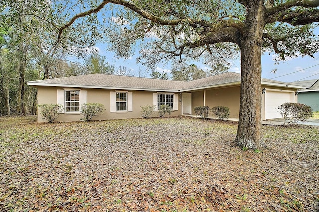 ranch-style home with an attached garage and stucco siding