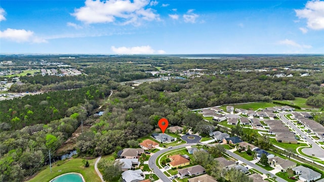 bird's eye view with a wooded view and a residential view