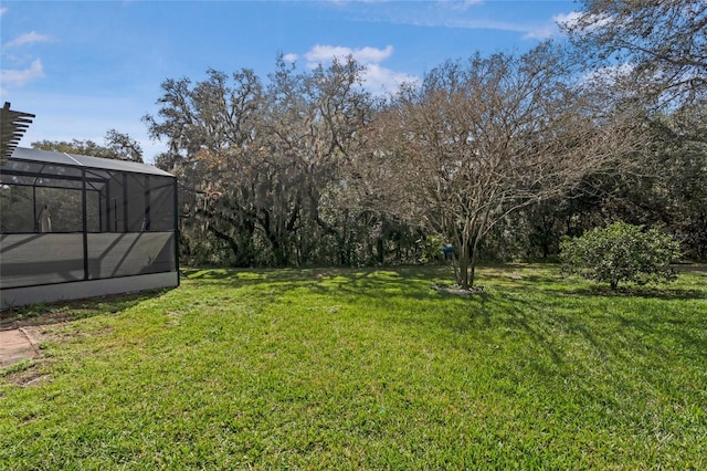 view of yard featuring glass enclosure