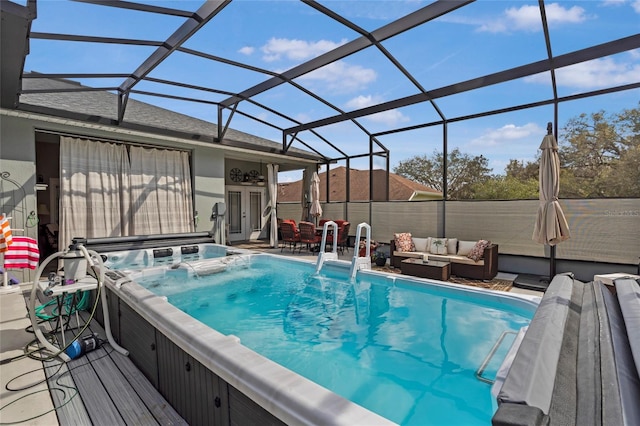 view of swimming pool with a lanai, a patio, a hot tub, and an outdoor hangout area