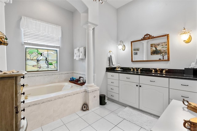 bathroom featuring a garden tub, decorative columns, vanity, and tile patterned floors