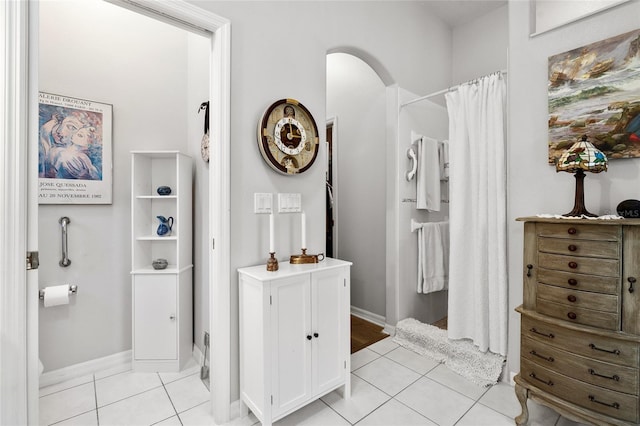 full bathroom with baseboards, a shower with curtain, and tile patterned floors