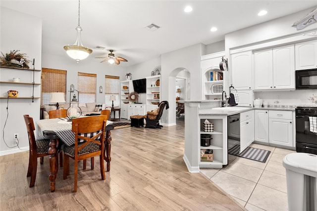 dining space with light wood finished floors, visible vents, arched walkways, a ceiling fan, and recessed lighting