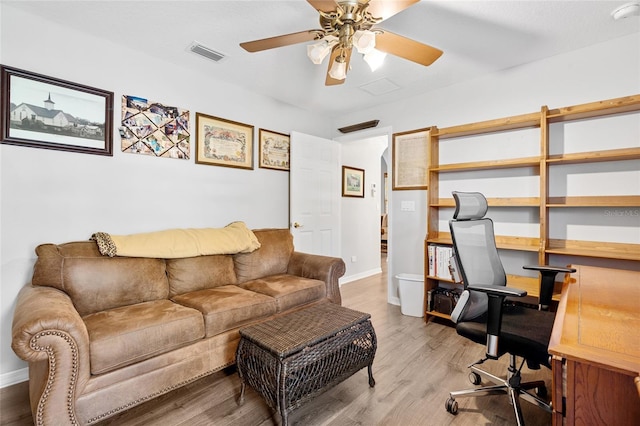 office with a ceiling fan, baseboards, visible vents, and wood finished floors