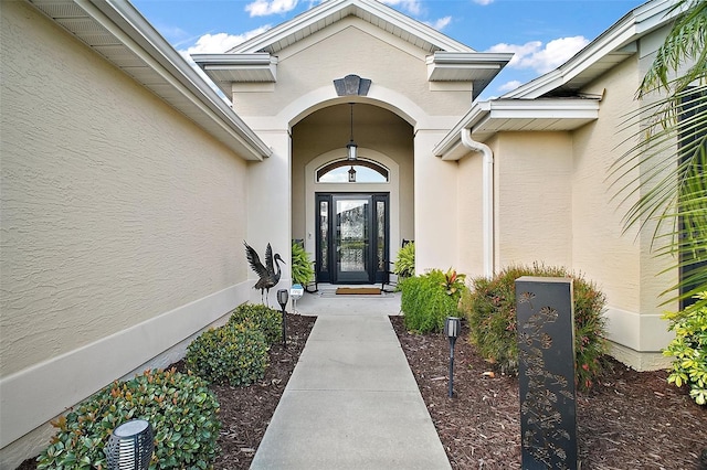 view of exterior entry with stucco siding