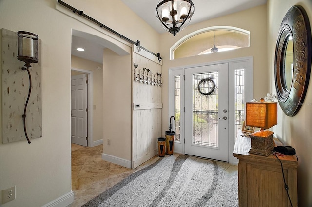 entrance foyer with baseboards and a barn door