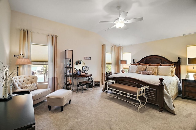 bedroom featuring light carpet, vaulted ceiling, and a ceiling fan