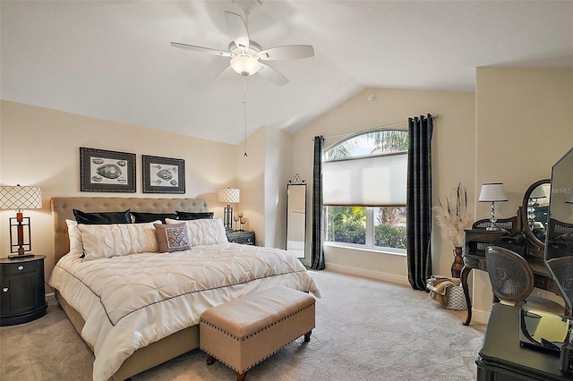 carpeted bedroom with vaulted ceiling, a ceiling fan, and baseboards