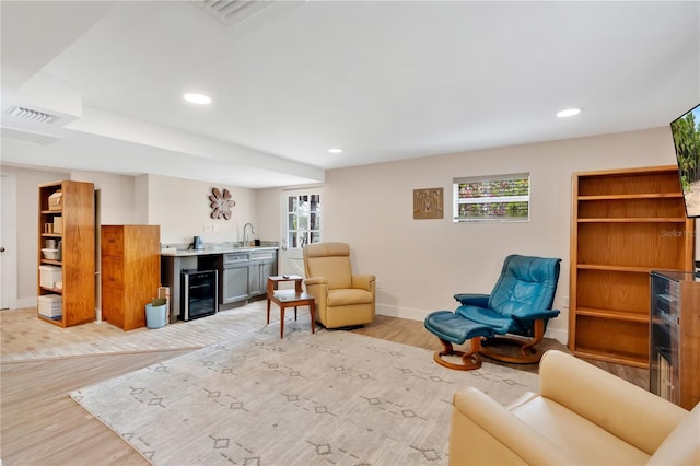 living area featuring wine cooler, recessed lighting, visible vents, baseboards, and light wood-type flooring