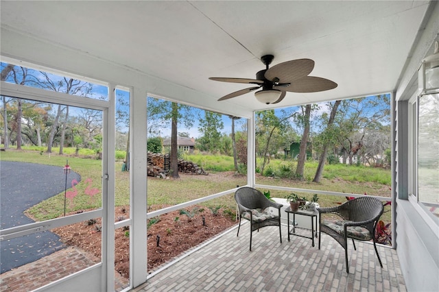 sunroom / solarium with a ceiling fan