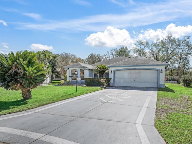 view of front facade with stucco siding, concrete driveway, and a front yard