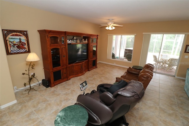 living room featuring light tile patterned floors, ceiling fan, and baseboards