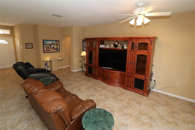 living room featuring visible vents, ceiling fan, baseboards, and light tile patterned floors