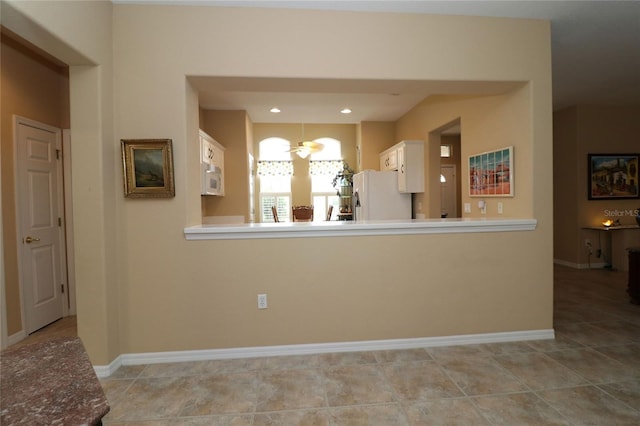 kitchen featuring light tile patterned flooring, recessed lighting, white appliances, baseboards, and white cabinets