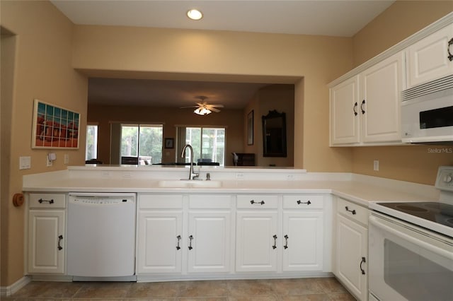 kitchen featuring light countertops, white cabinetry, a sink, ceiling fan, and white appliances