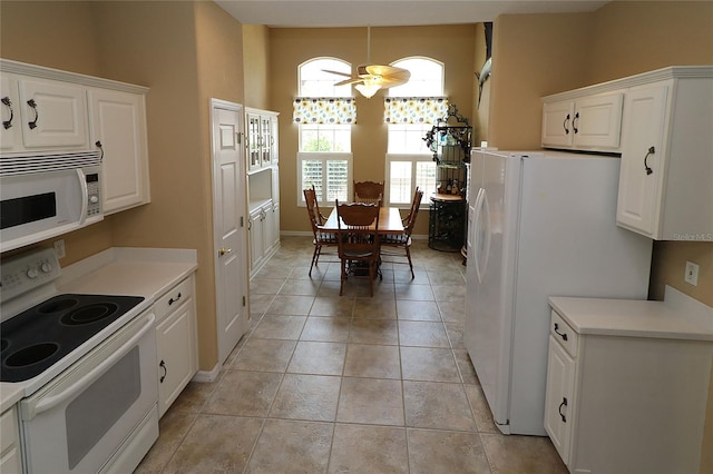 kitchen featuring light tile patterned floors, light countertops, white cabinets, ceiling fan, and white appliances