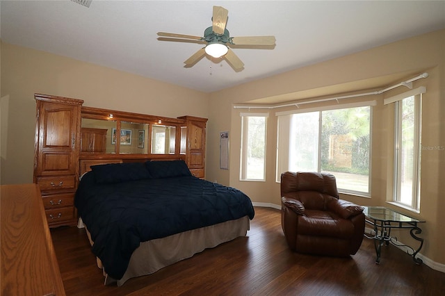 bedroom with wood finished floors and baseboards