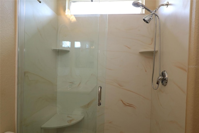 full bath featuring a marble finish shower