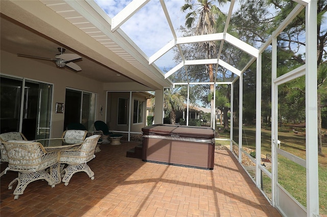 sunroom / solarium with ceiling fan and beam ceiling