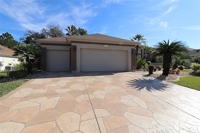 view of front facade with a shingled roof, central air condition unit, driveway, and stucco siding