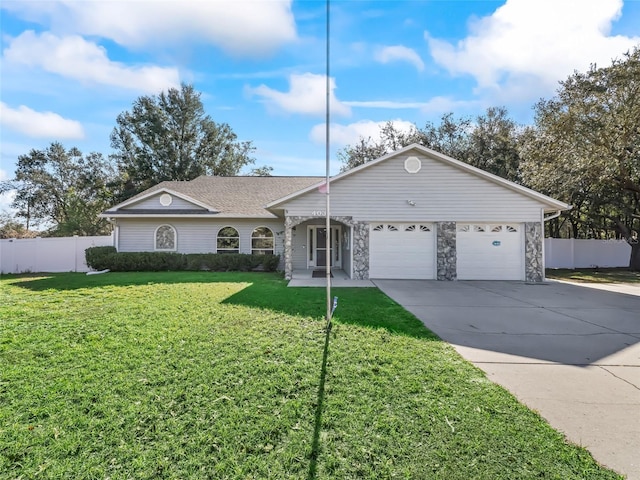 single story home featuring a front yard, concrete driveway, and fence